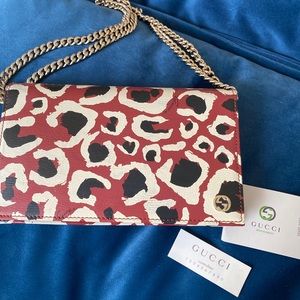 GUCCI maroon leopard wallet on a chain , used once. Shows no signs of wear!